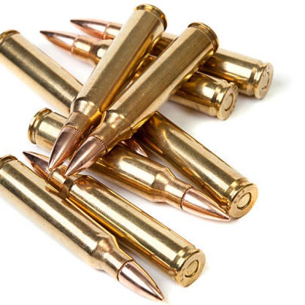 A loose pile of rifle bullets. Focus is on the tips of the two bullets on top. Image has a fairly shallow depth of field.